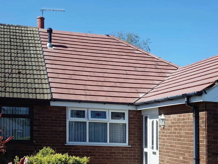 New red tiled roof on a semi-detached bungalow, next door's older tiles on the left