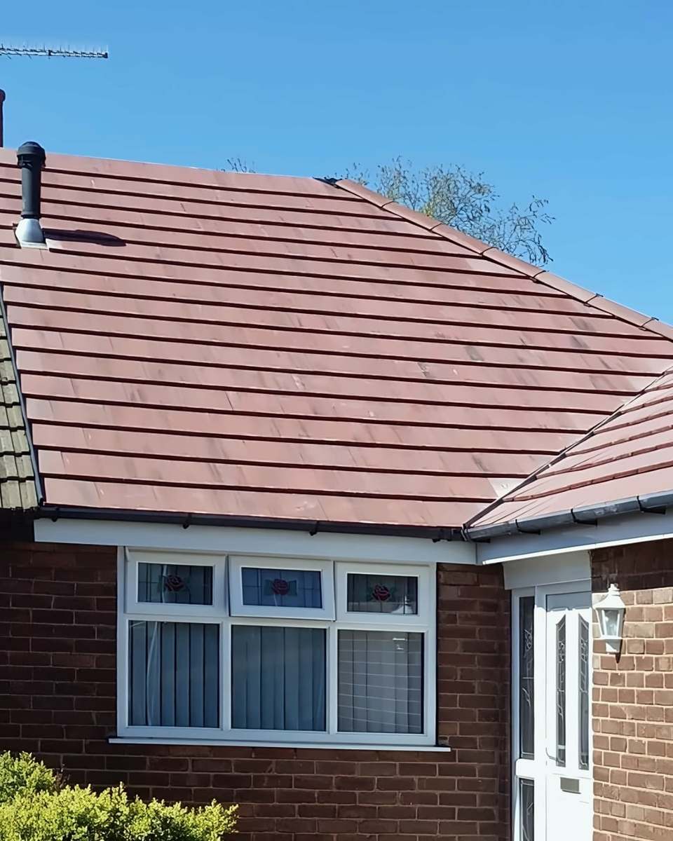 New red tiled roof on a semi-detached bungalow, next door's older tiles on the left
